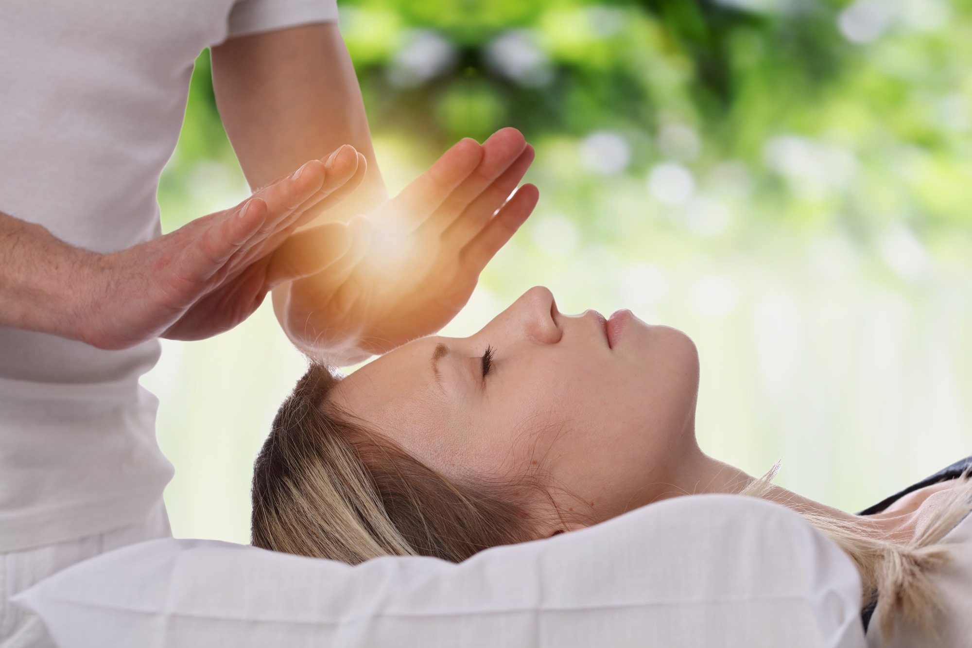 Woman having reiki healing treatment